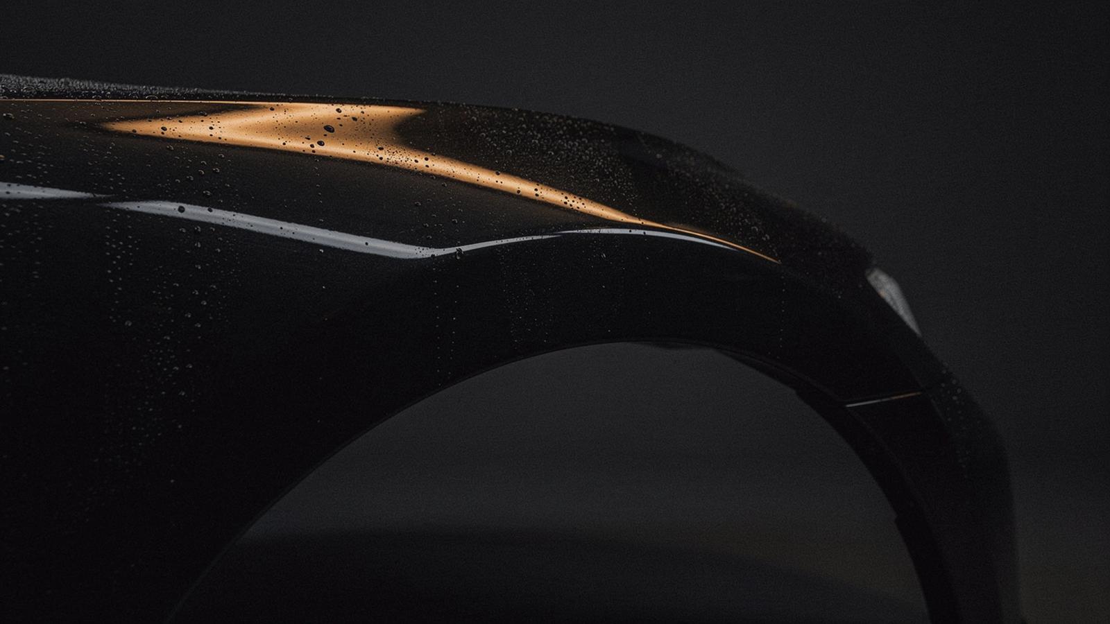 Reflective dark car fender under studio light after ceramic coating in Kyiv